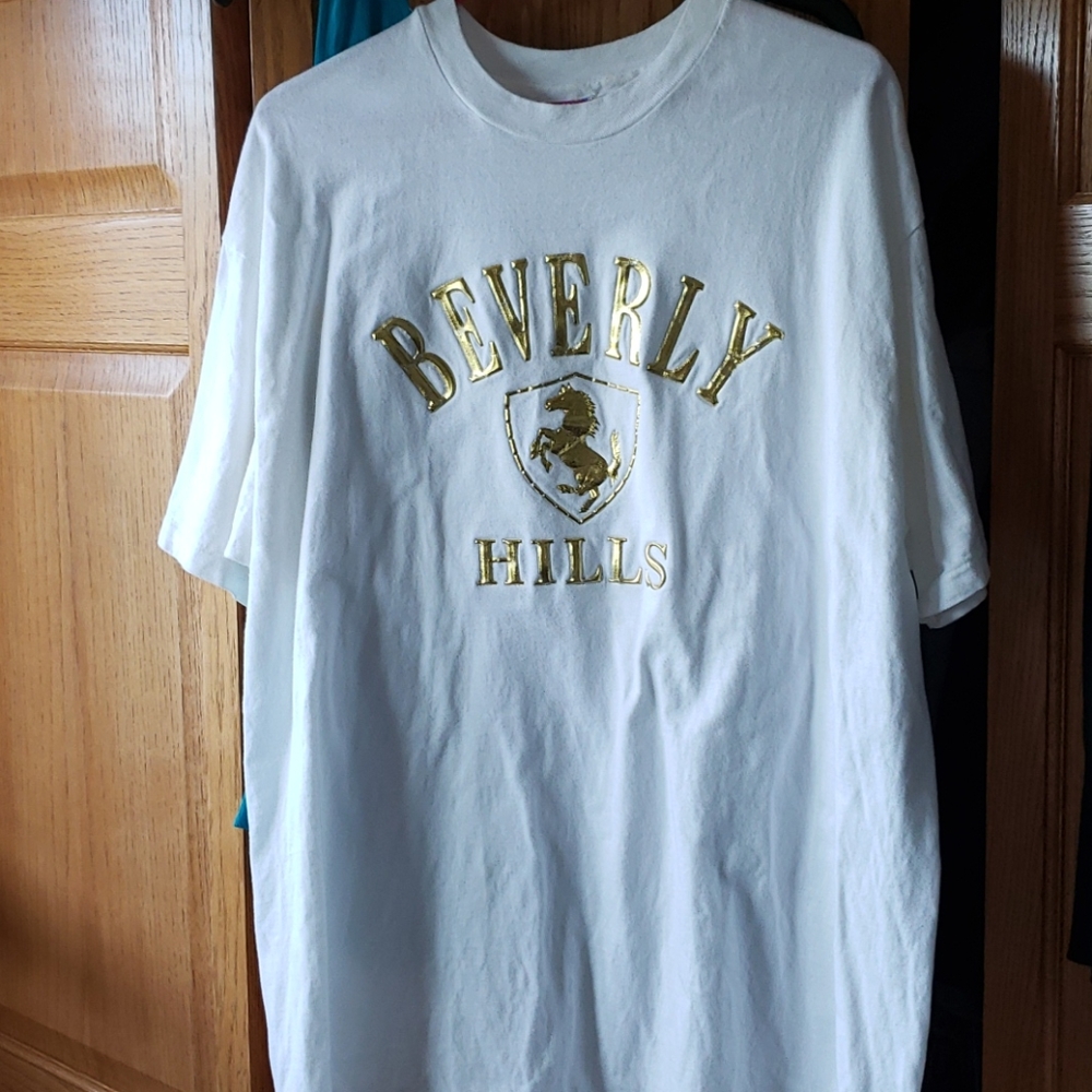 Donated white t shirt with gold puffy letters. XL